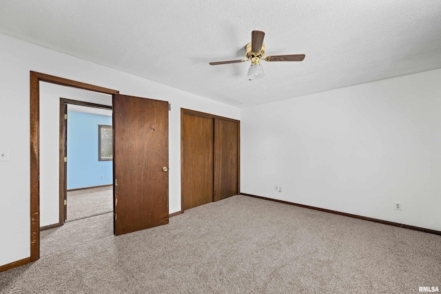 3796 160th St, Bryant, IA 52727 - unfurnished bedroom featuring carpet flooring, ceiling fan, and a textured ceiling