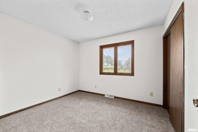 3796 160th St, Bryant, IA 52727 - unfurnished bedroom featuring carpet and a textured ceiling