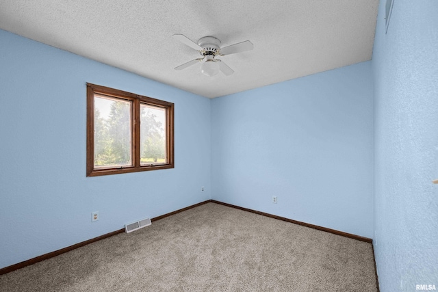 3796 160th St, Bryant, IA 52727 - spare room featuring ceiling fan, carpet floors, and a textured ceiling