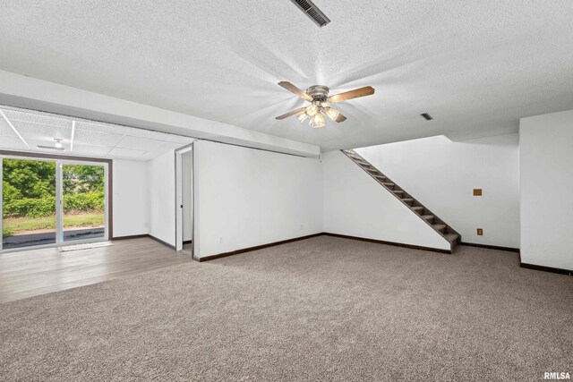 3796 160th St, Bryant, IA 52727 - unfurnished room featuring carpet, stairway, ceiling fan, and a textured ceiling