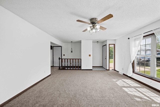 3796 160th St, Bryant, IA 52727 - spare room featuring a ceiling fan, carpet floors, and a textured ceiling