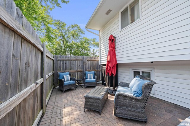 404 34th Ave, East Moline, IL 61244 - fenced backyard with a patio area and an outdoor living space