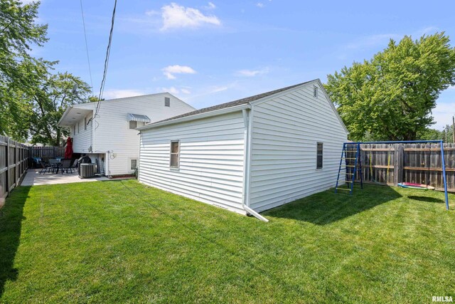 404 34th Ave, East Moline, IL 61244 - rear view of house with a fenced backyard and a patio