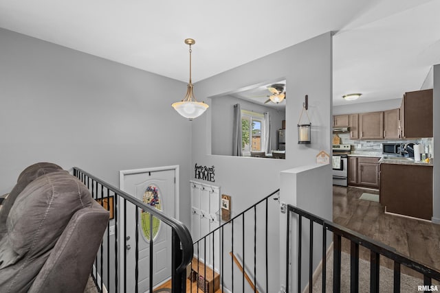 404 34th Ave, East Moline, IL 61244 - hallway with an upstairs landing and dark wood-style floors