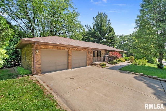 4319 7th Ave, Moline, IL 61265 - ranch-style home featuring brick siding, driveway, a garage, covered porch, and a front lawn