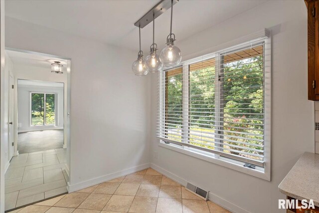 4319 7th Ave, Moline, IL 61265 - unfurnished dining area with baseboards and light tile patterned flooring