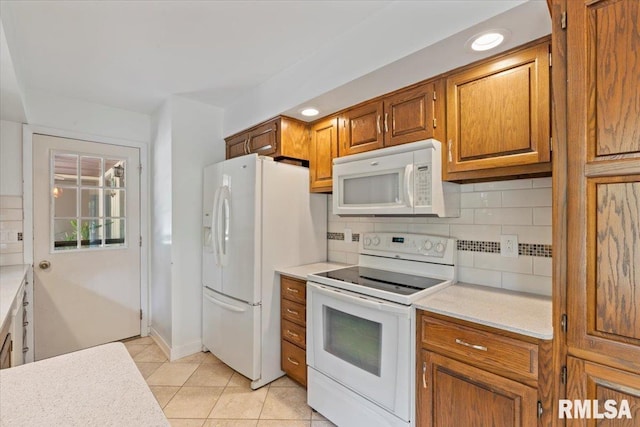4319 7th Ave, Moline, IL 61265 - kitchen featuring white appliances, light countertops, decorative backsplash, brown cabinets, and light tile patterned floors