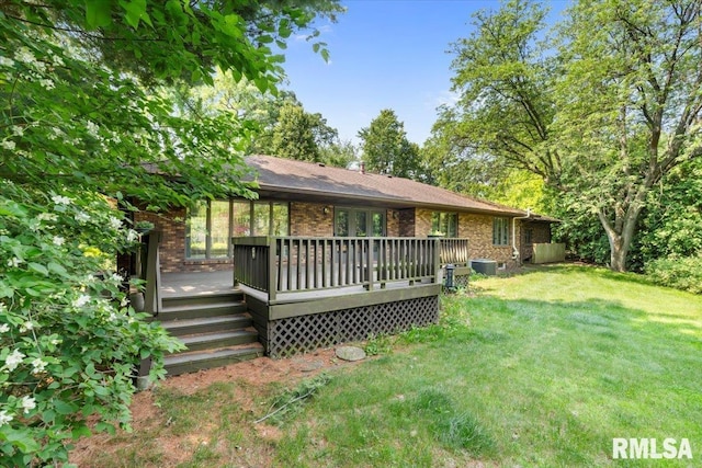 4319 7th Ave, Moline, IL 61265 - rear view of property with brick siding, a lawn, and a wooden deck