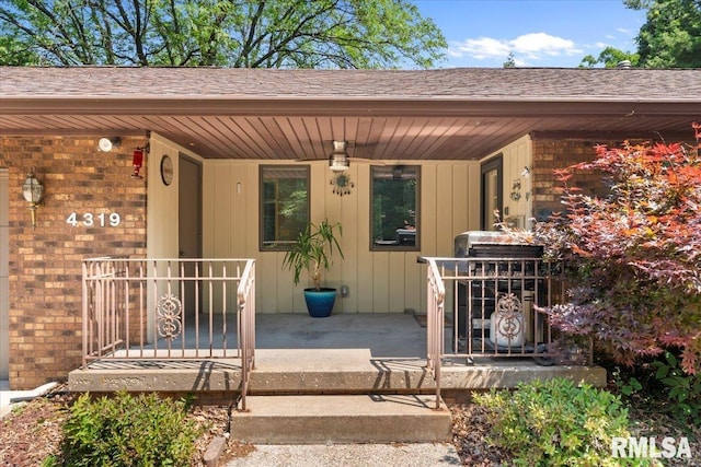 4319 7th Ave, Moline, IL 61265 - entrance to property featuring a porch, roof with shingles, and brick siding