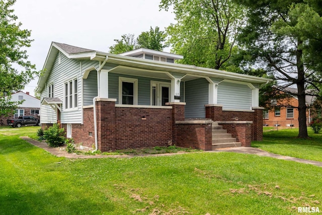 614 S Calumet St, Marion, IL 62959 - view of front facade with a porch, a front lawn, and brick siding