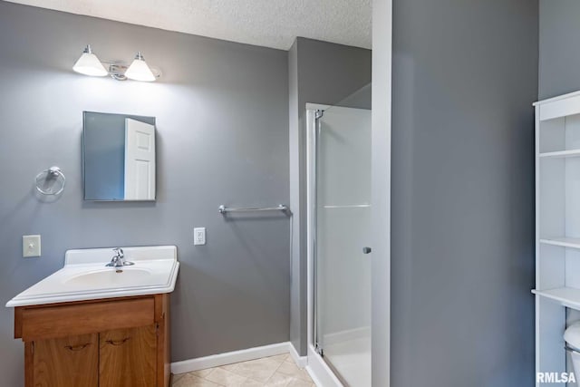 614 S Calumet St, Marion, IL 62959 - bathroom with a stall shower, vanity, tile patterned flooring, and a textured ceiling