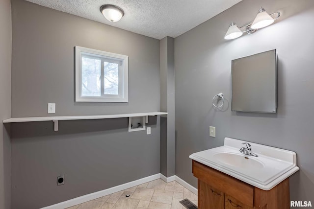 614 S Calumet St, Marion, IL 62959 - bathroom with vanity and a textured ceiling
