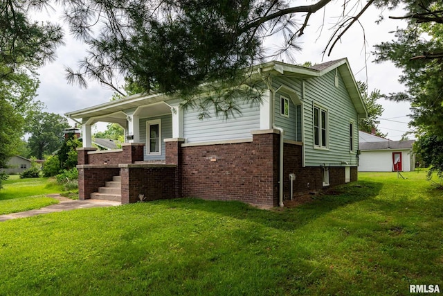 614 S Calumet St, Marion, IL 62959 - view of front facade featuring a front lawn, brick siding, covered porch, and a garage