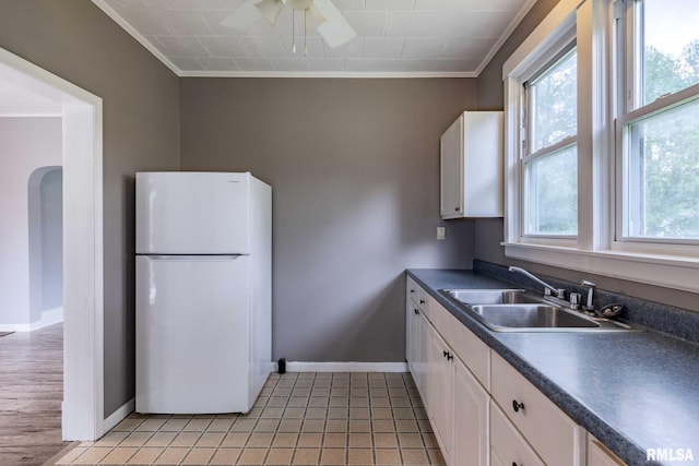 614 S Calumet St, Marion, IL 62959 - kitchen with freestanding refrigerator, crown molding, ceiling fan, dark countertops, and white cabinets