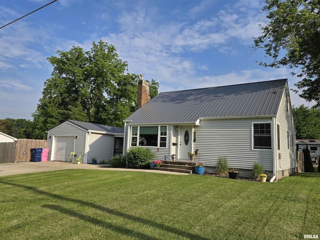 610 NW 6th St, Aledo, IL 61231 - view of front facade featuring a chimney, driveway, a metal roof, a garage, and an outbuilding