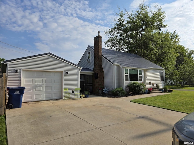 610 NW 6th St, Aledo, IL 61231 - view of front of property with a chimney, driveway, a front lawn, a garage, and a metal roof