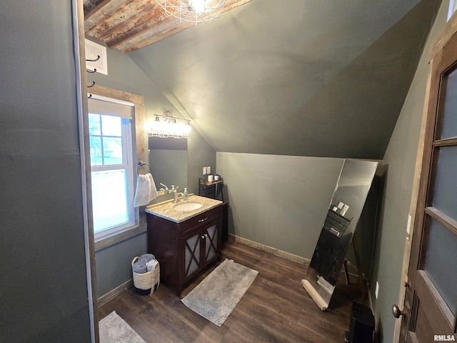 610 NW 6th St, Aledo, IL 61231 - bathroom featuring lofted ceiling, plenty of natural light, vanity, and wood finished floors