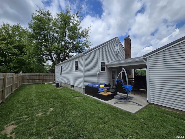 610 NW 6th St, Aledo, IL 61231 - back of house with a fenced backyard, a patio area, an outdoor hangout area, and a chimney
