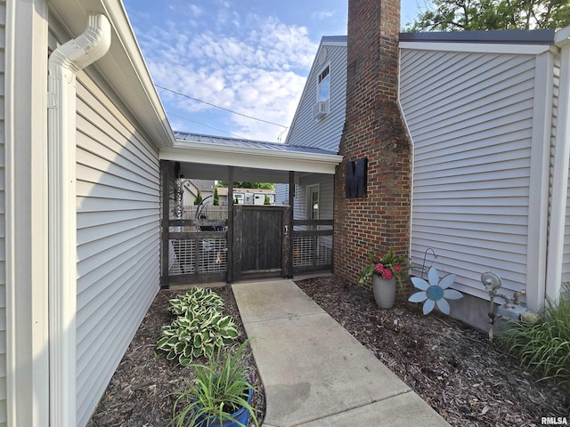 610 NW 6th St, Aledo, IL 61231 - view of exterior entry with a gate and a chimney