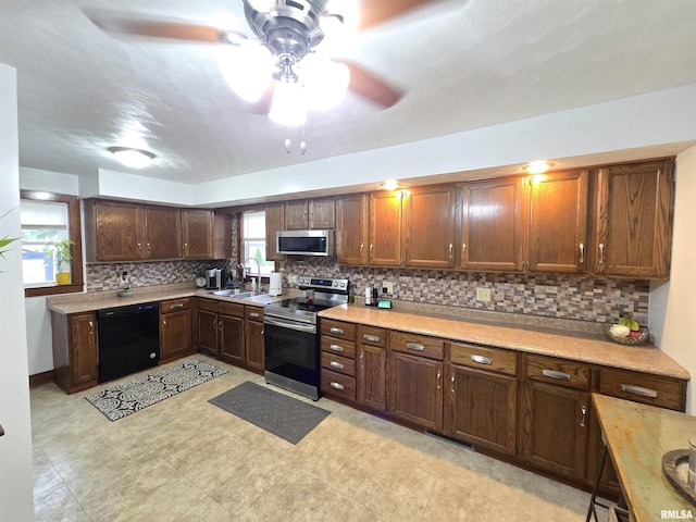 610 NW 6th St, Aledo, IL 61231 - kitchen with appliances with stainless steel finishes, a ceiling fan, light countertops, and backsplash