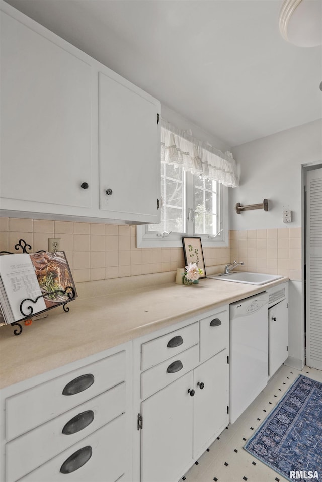 3626 15th Avenue Ct, Moline, IL 61265 - kitchen with white dishwasher, light countertops, white cabinetry, backsplash, and light flooring