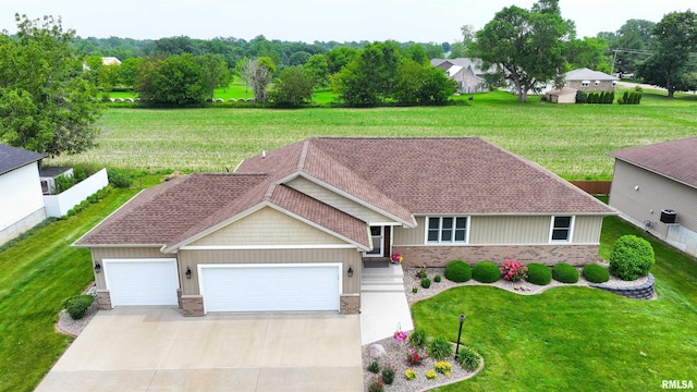 101 Prairie View Ct, Clinton, IA 52732 - view of front of property featuring a garage, brick siding, driveway, a front yard, and a shingled roof