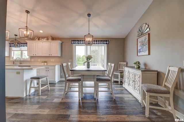 101 Prairie View Ct, Clinton, IA 52732 - dining area featuring a chandelier, vaulted ceiling, and dark wood-style floors