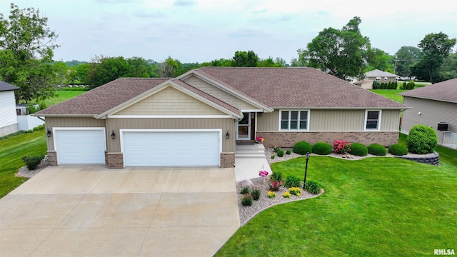 101 Prairie View Ct, Clinton, IA 52732 - view of front of house with brick siding, driveway, a garage, a front yard, and a shingled roof