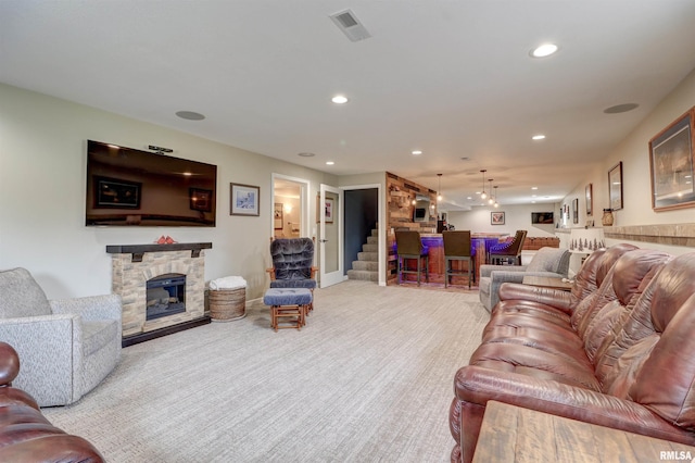 101 Prairie View Ct, Clinton, IA 52732 - carpeted living room with bar area, recessed lighting, a fireplace, and stairs