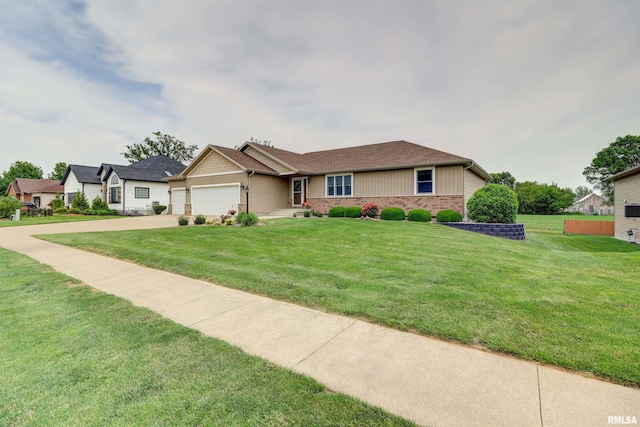 101 Prairie View Ct, Clinton, IA 52732 - view of front facade with a garage, concrete driveway, a front yard, and brick siding