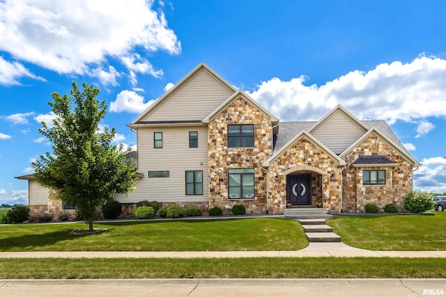 5541 Pigeon Creek Rd, Bettendorf, IA 52722 - view of front of house with stone siding and a front lawn