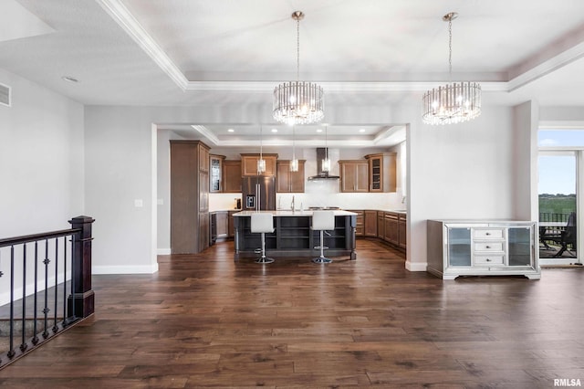 5541 Pigeon Creek Rd, Bettendorf, IA 52722 - kitchen featuring stainless steel fridge with ice dispenser, brown cabinets, a breakfast bar, a tray ceiling, and a chandelier