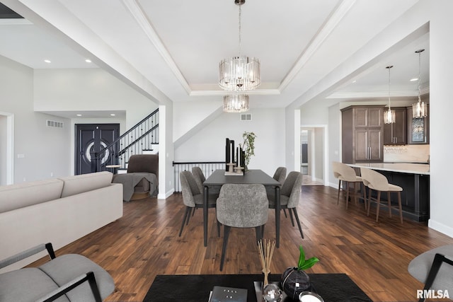 5541 Pigeon Creek Rd, Bettendorf, IA 52722 - dining area with a tray ceiling, a chandelier, dark wood finished floors, recessed lighting, and ornamental molding