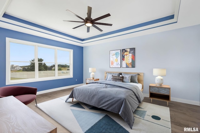 5541 Pigeon Creek Rd, Bettendorf, IA 52722 - bedroom with a raised ceiling and wood finished floors