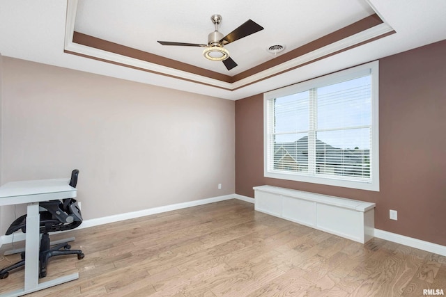 5541 Pigeon Creek Rd, Bettendorf, IA 52722 - unfurnished office with a raised ceiling, light wood-type flooring, and ceiling fan