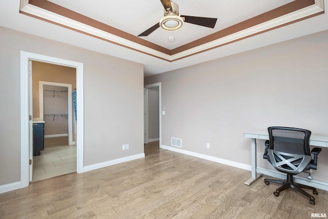 5541 Pigeon Creek Rd, Bettendorf, IA 52722 - unfurnished office with a tray ceiling, light wood-type flooring, and a ceiling fan