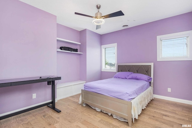 5541 Pigeon Creek Rd, Bettendorf, IA 52722 - bedroom featuring light wood-type flooring and a ceiling fan