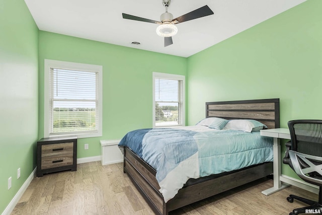 5541 Pigeon Creek Rd, Bettendorf, IA 52722 - bedroom featuring wood finished floors and ceiling fan