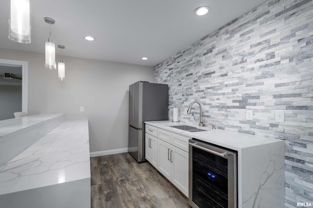 5541 Pigeon Creek Rd, Bettendorf, IA 52722 - indoor wet bar with beverage cooler, freestanding refrigerator, recessed lighting, hanging light fixtures, and dark wood-style flooring