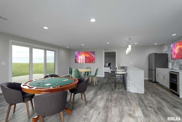 5541 Pigeon Creek Rd, Bettendorf, IA 52722 - game room featuring beverage cooler, recessed lighting, and wood finished floors