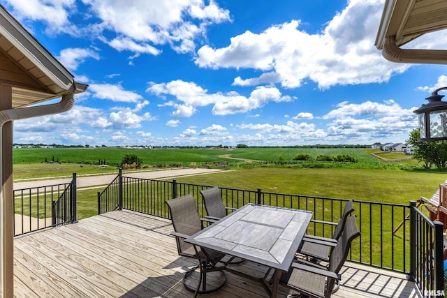 5541 Pigeon Creek Rd, Bettendorf, IA 52722 - deck featuring a rural view, outdoor dining space, and a lawn