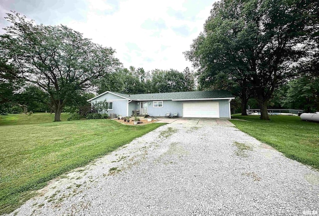 3770 153rd St, Blue Grass, IA 52726 - single story home featuring gravel driveway, an attached garage, and a front lawn