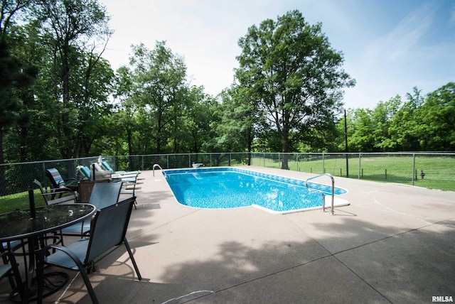 3770 153rd St, Blue Grass, IA 52726 - view of swimming pool featuring a patio, view of scattered trees, and a diving board