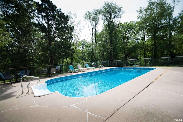 3770 153rd St, Blue Grass, IA 52726 - view of swimming pool featuring a patio and view of wooded area