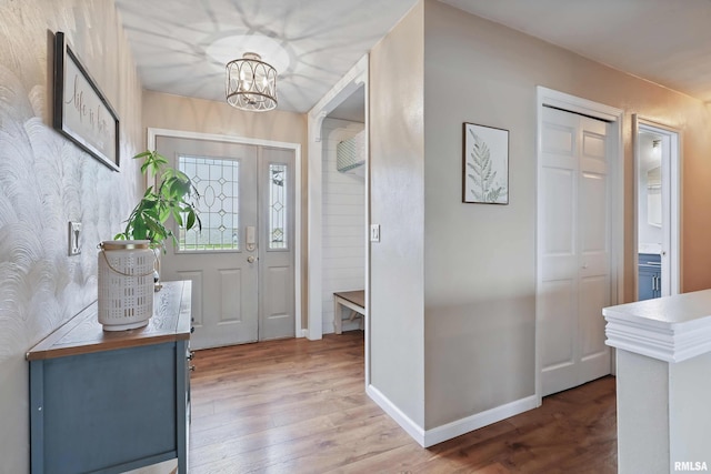 3770 153rd St, Blue Grass, IA 52726 - entrance foyer featuring wood finished floors, a chandelier, and wallpapered walls