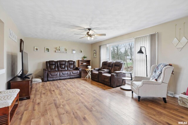 3770 153rd St, Blue Grass, IA 52726 - living area featuring a ceiling fan and light wood-style flooring