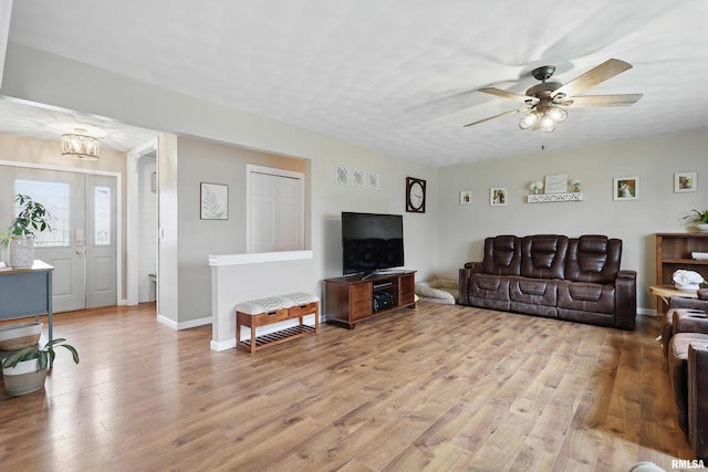 3770 153rd St, Blue Grass, IA 52726 - living room featuring a ceiling fan and light wood-style floors