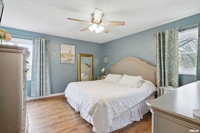 3770 153rd St, Blue Grass, IA 52726 - bedroom featuring light wood-style floors and a ceiling fan