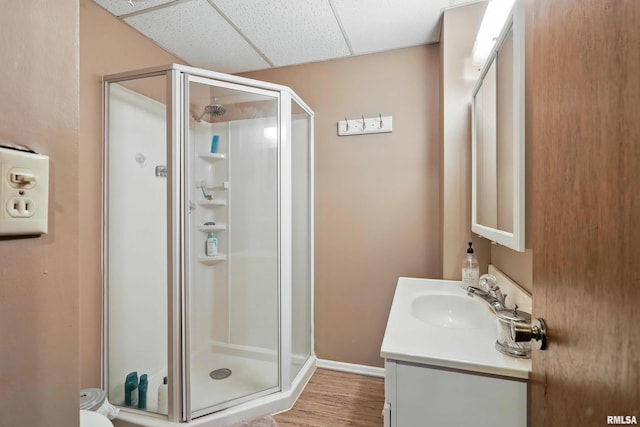 3770 153rd St, Blue Grass, IA 52726 - full bath featuring vanity, a shower stall, a drop ceiling, and wood finished floors