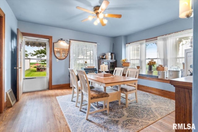 3292 110th St, Stockton, IA 52769 - dining space with healthy amount of natural light, a ceiling fan, and light wood-type flooring